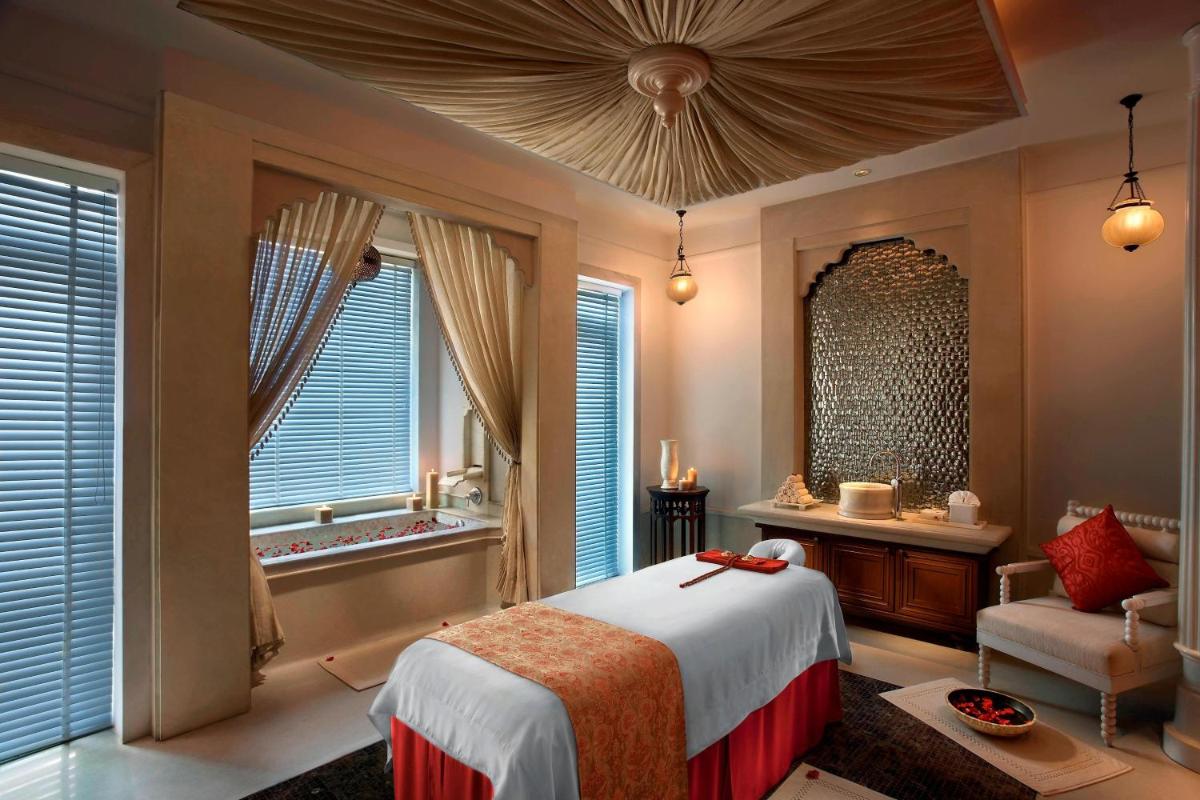 a bedroom with a large bed and a window at ITC Mughal, A Luxury Collection Resort & Spa, Agra in Agra