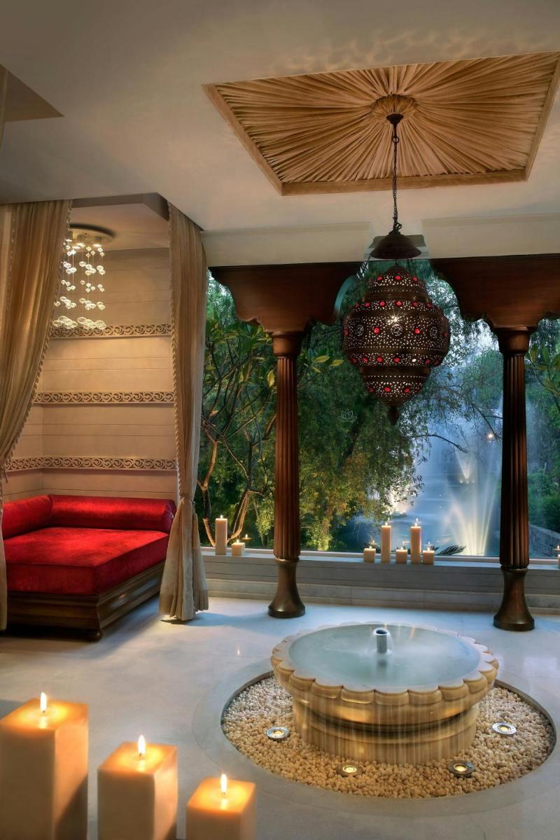 a living room with a tub with candles and a couch at ITC Mughal, A Luxury Collection Resort & Spa, Agra in Agra
