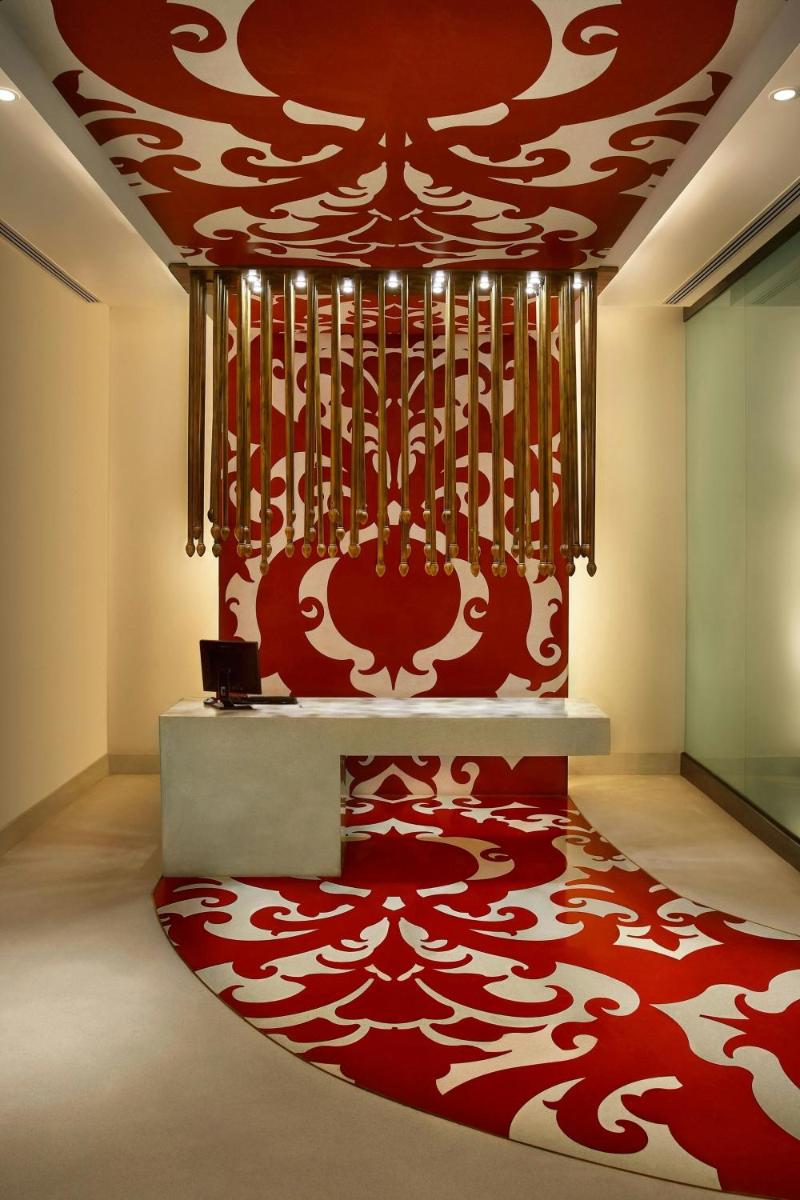 a room with a red and white carpet and a table at ITC Mughal, A Luxury Collection Resort & Spa, Agra in Agra