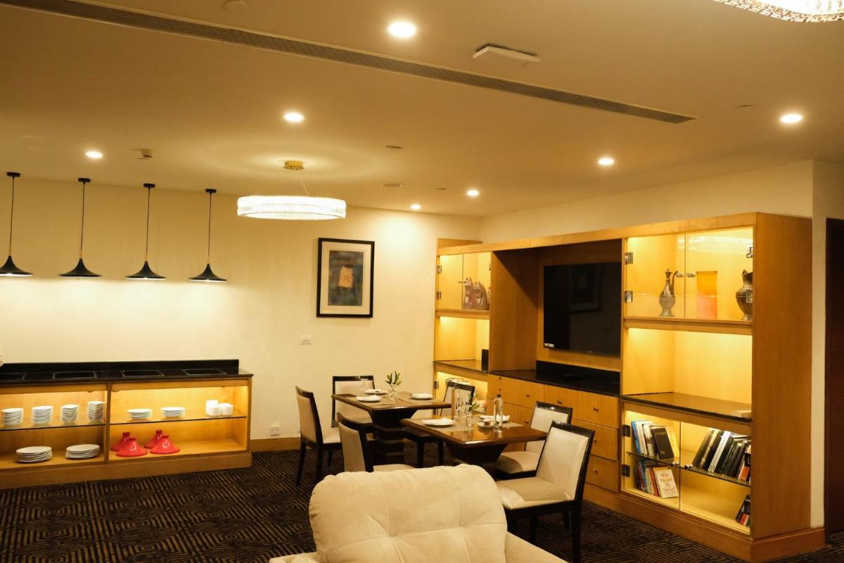 a dining room with a table and chairs at Crowne Plaza Today Gurugram by IHG in Gurgaon