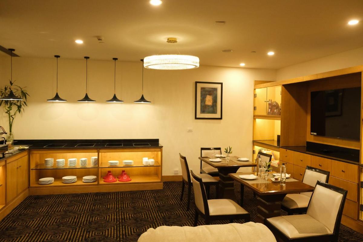 a dining room with a table and chairs at Crowne Plaza Today Gurugram by IHG in Gurgaon