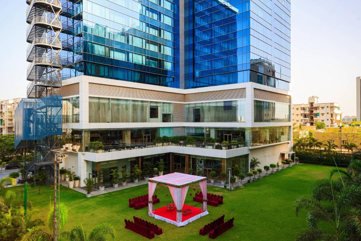a large building with a table in front of it at Renaissance Ahmedabad Hotel in Ahmedabad