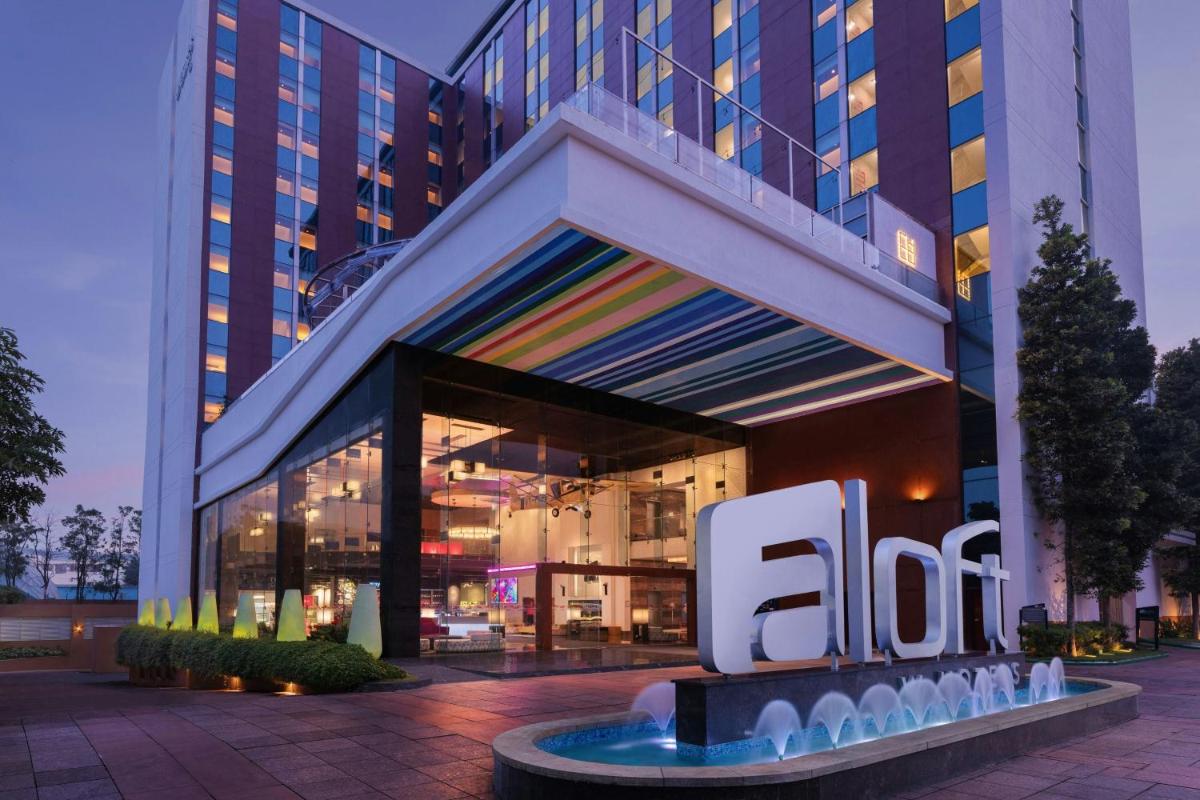an office building with a sign in front of it at Aloft Bengaluru Outer Ring Road in Bengaluru