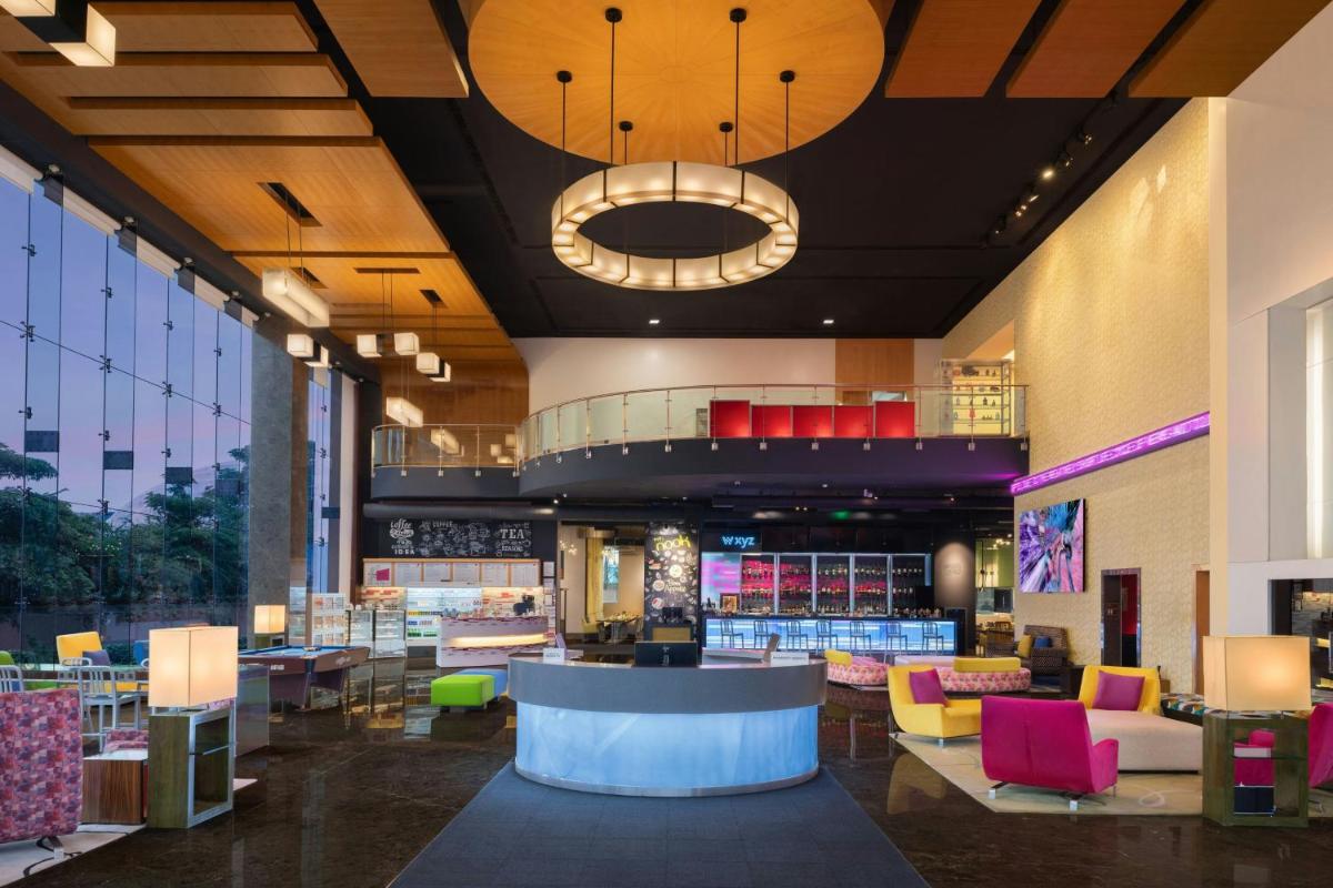 a lobby of a store with colorful furniture at Aloft Bengaluru Outer Ring Road in Bengaluru