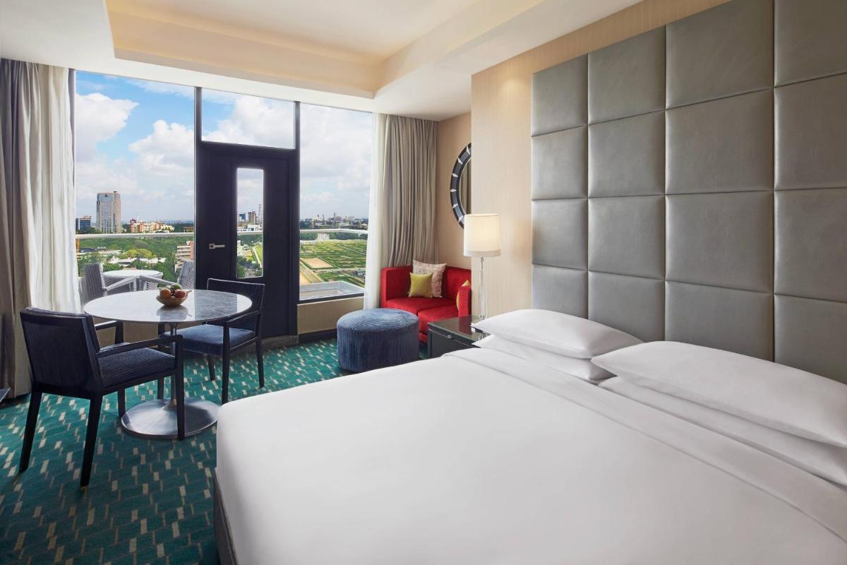 a hotel room with a bed and a table at Renaissance Bengaluru Race Course Hotel in Bengaluru