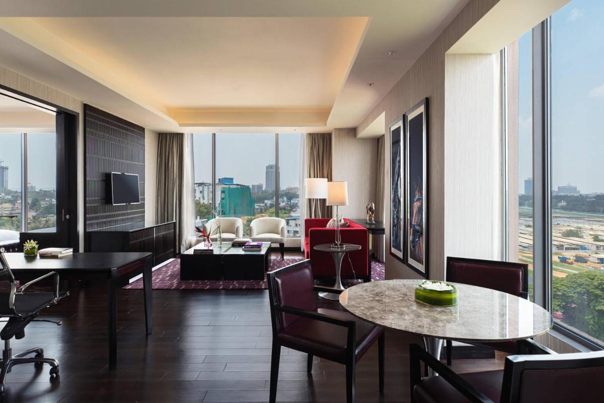 a hotel room with a view of a living room at Renaissance Bengaluru Race Course Hotel in Bengaluru