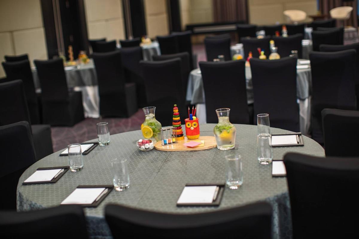 a table with a tray of food and drinks on it at Renaissance Bengaluru Race Course Hotel in Bengaluru