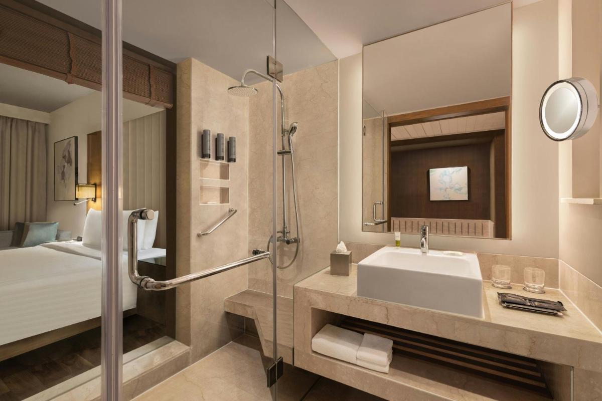 a bathroom with a sink and a shower at Courtyard by Marriott Gurugram Downtown in Gurgaon