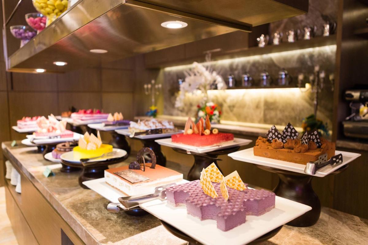 a buffet line with many different types of cakes at Courtyard by Marriott Gurugram Downtown in Gurgaon