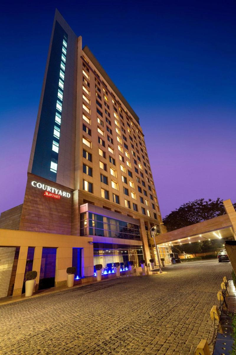 a large building with lights on top of it at Courtyard by Marriott Gurugram Downtown in Gurgaon