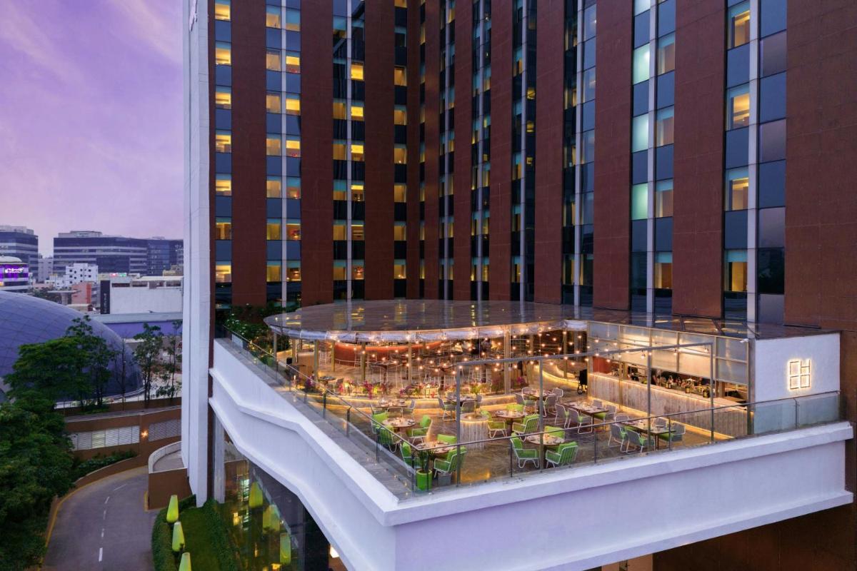 a view of a building with a restaurant on it at Aloft Bengaluru Outer Ring Road in Bengaluru