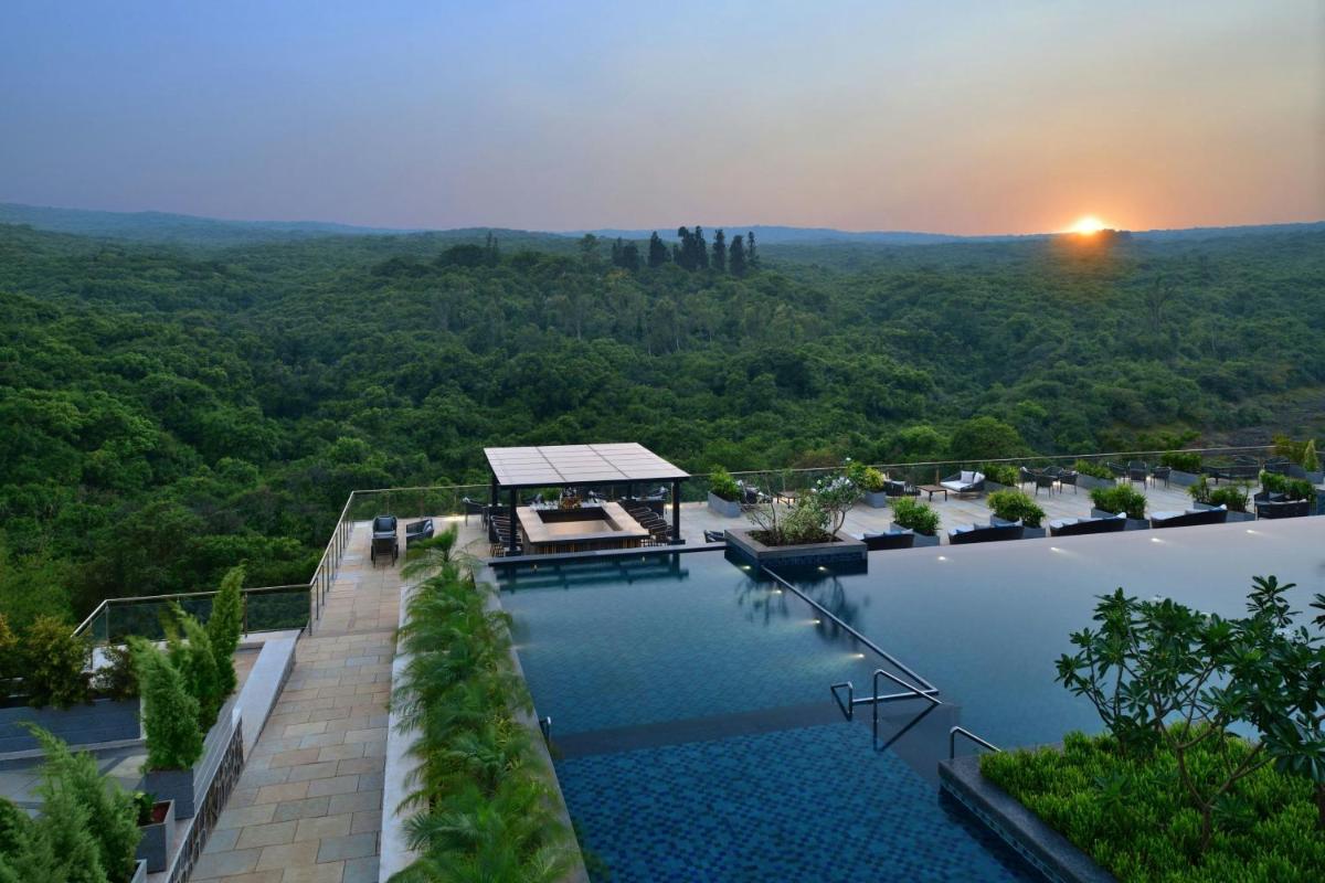 an aerial view of a house with a swimming pool at Courtyard by Marriott Mahabaleshwar in Mahabaleshwar