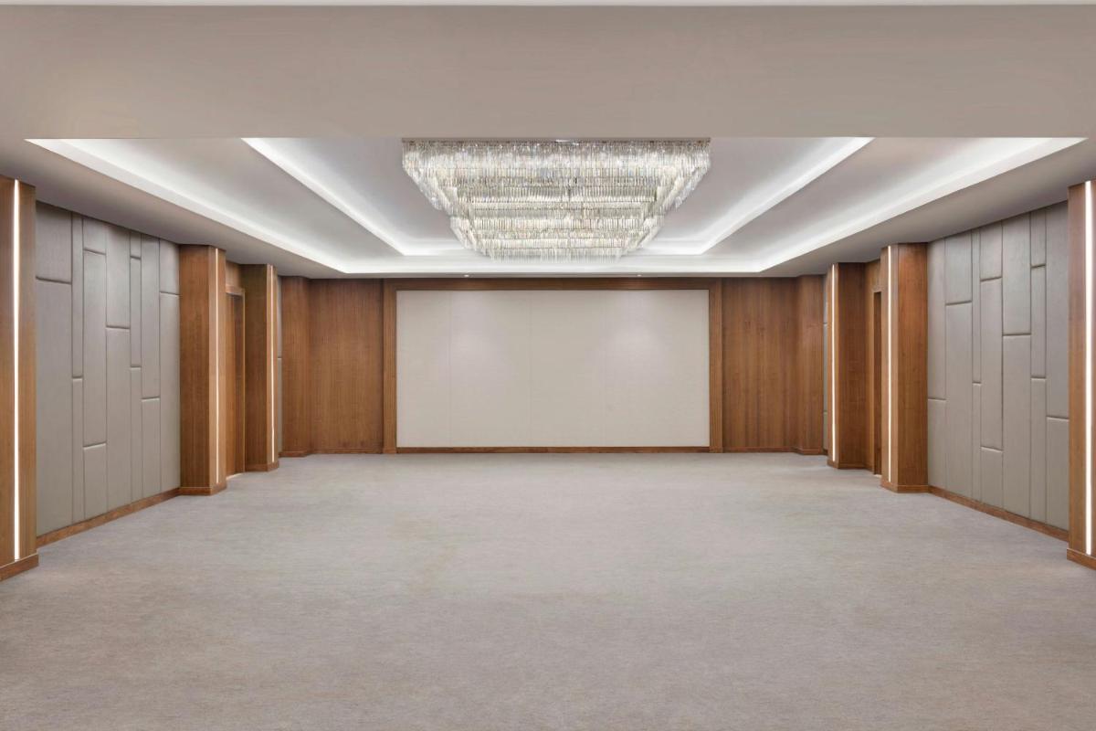 an empty hallway with lockers and a chandelier at Courtyard by Marriott Mahabaleshwar in Mahabaleshwar