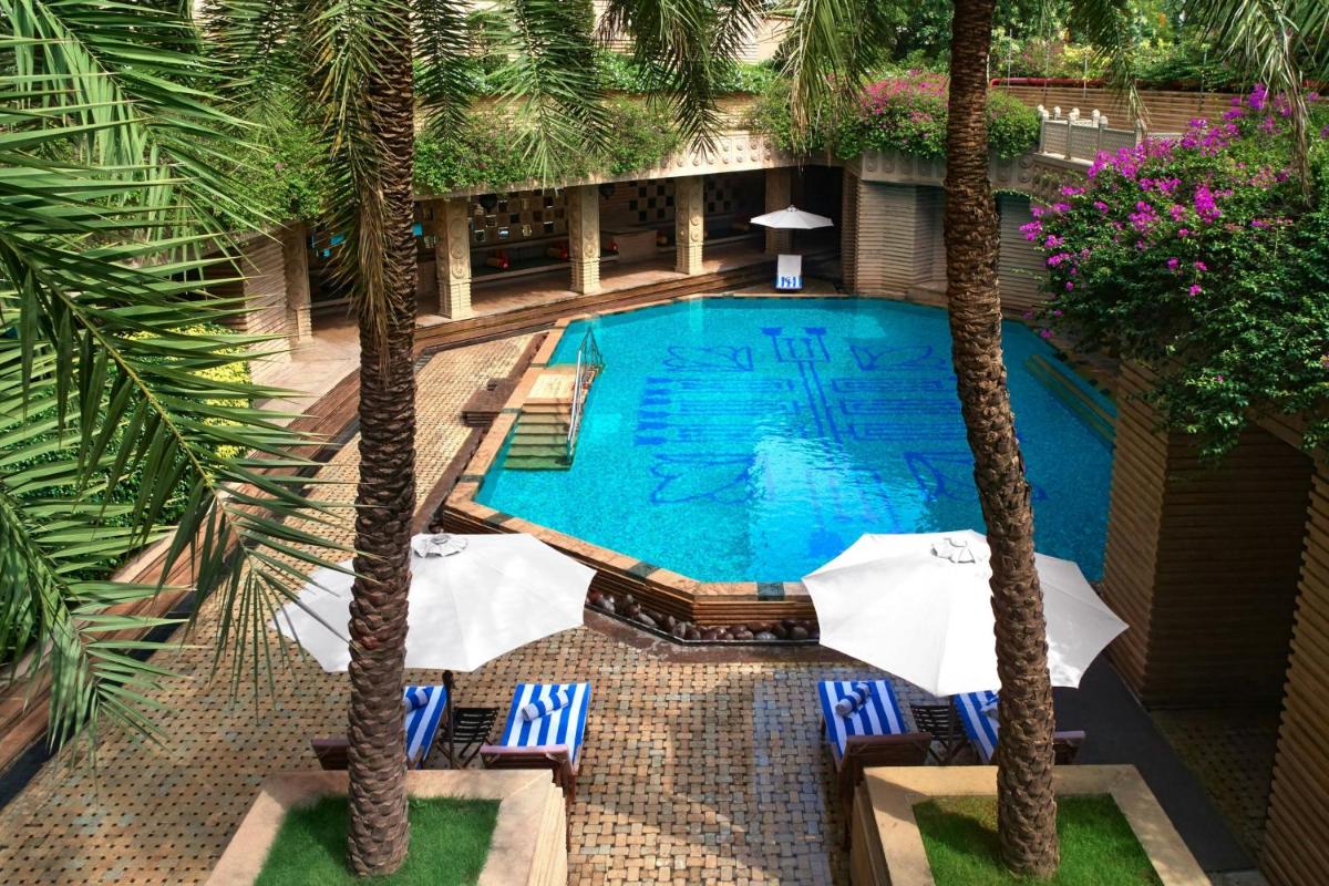 an overhead view of a swimming pool with palm trees at Courtyard by Marriott Hyderabad in Hyderabad