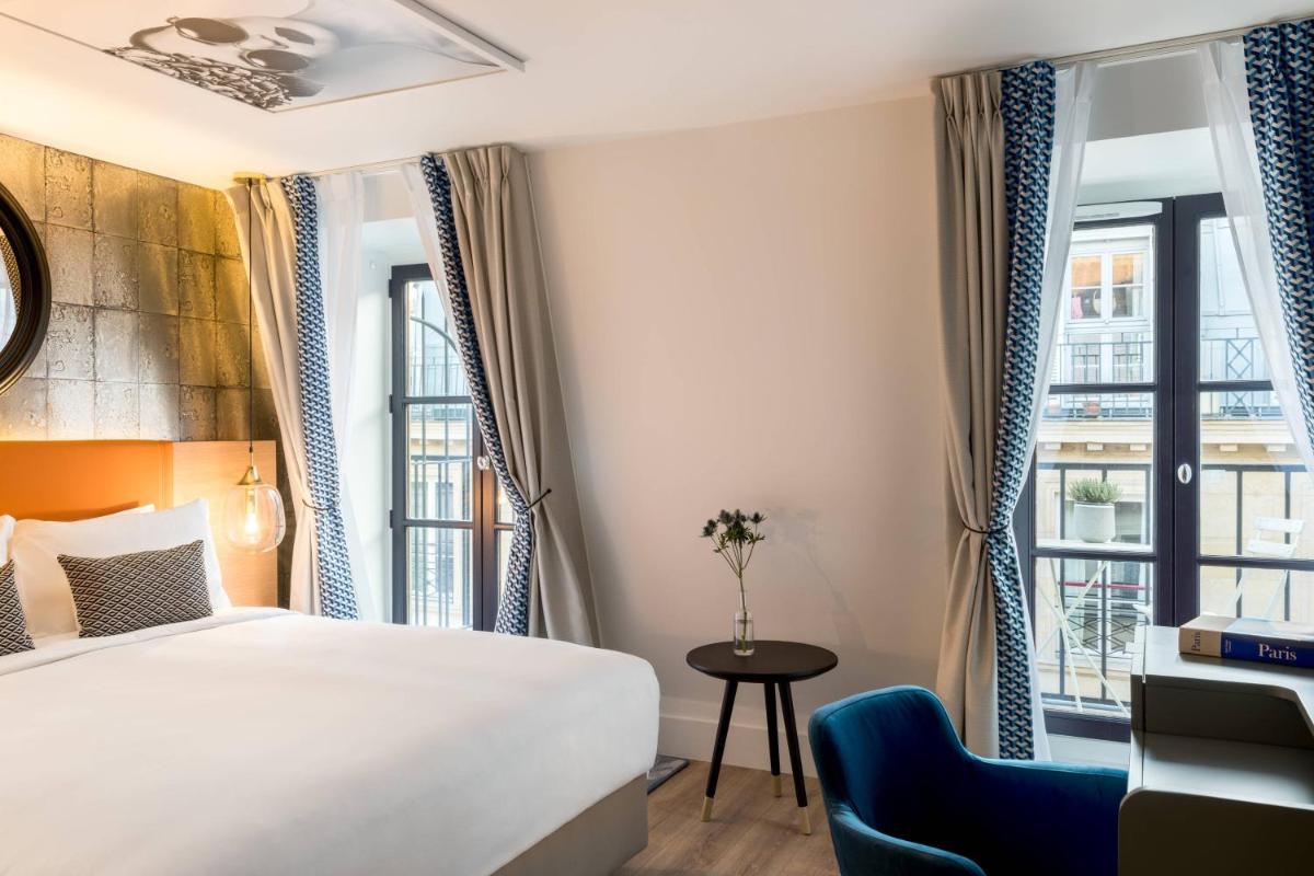 Un ou plusieurs lits dans un hébergement de l'établissement Renaissance Paris Vendome Hotel