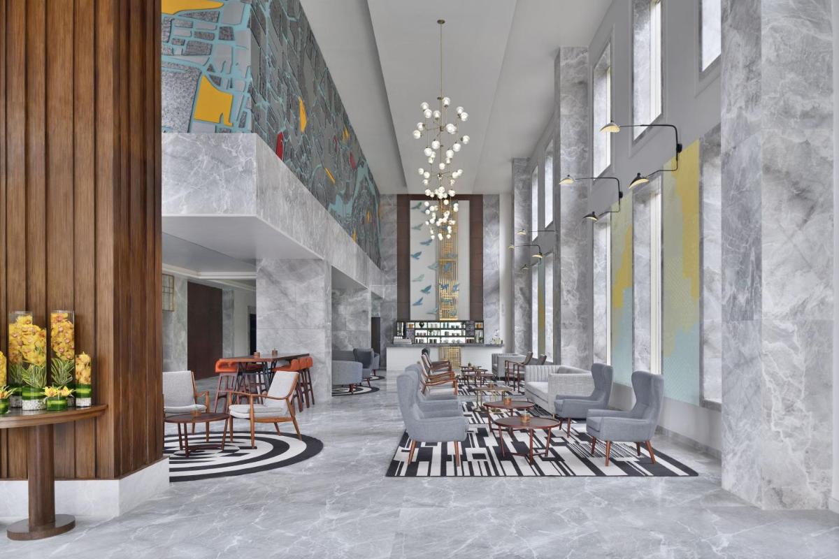 a rendering of a lobby with chairs and tables at Le Meridien Hyderabad in Hyderabad