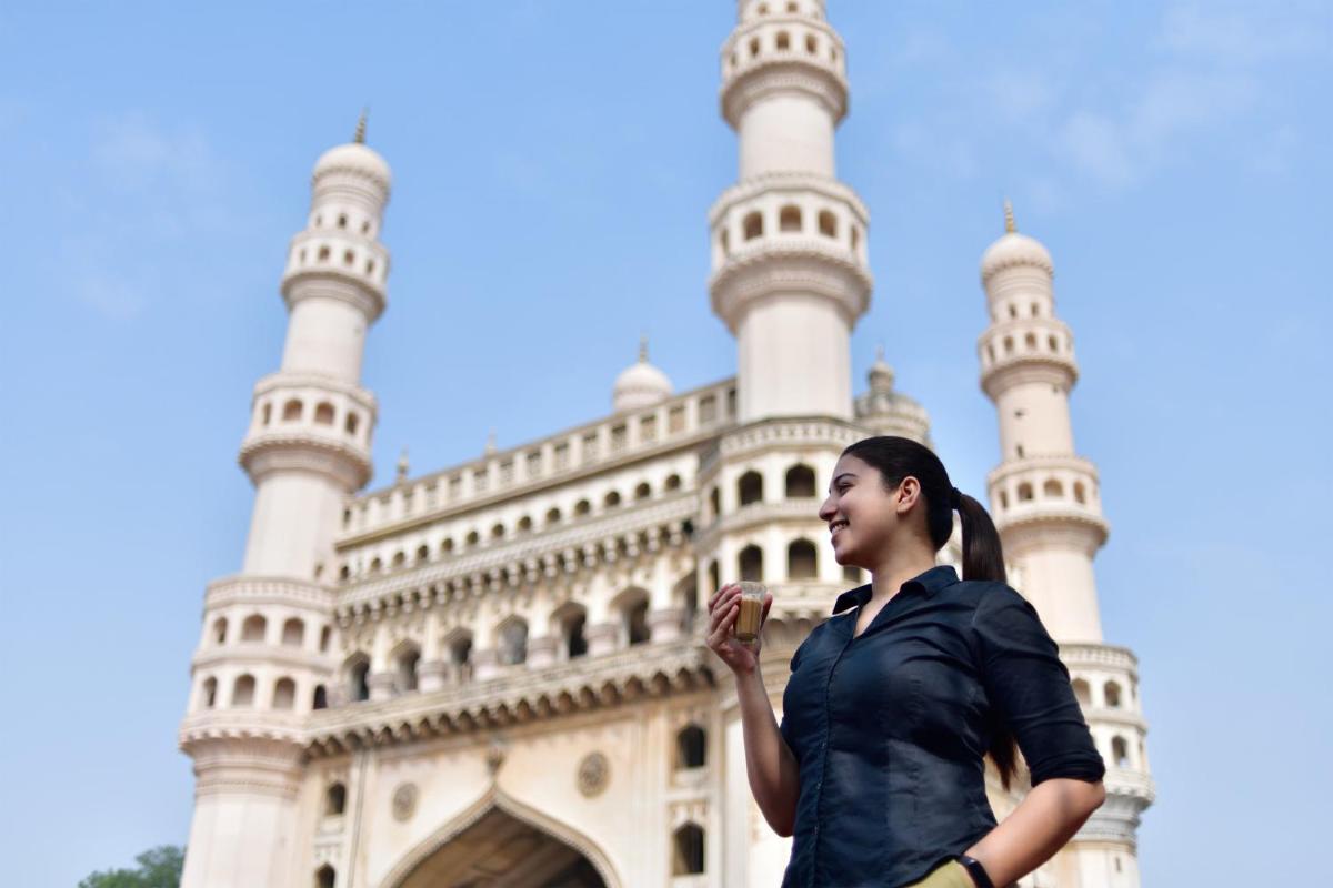 a woman standing in front of a mosque at Le Meridien Hyderabad in Hyderabad