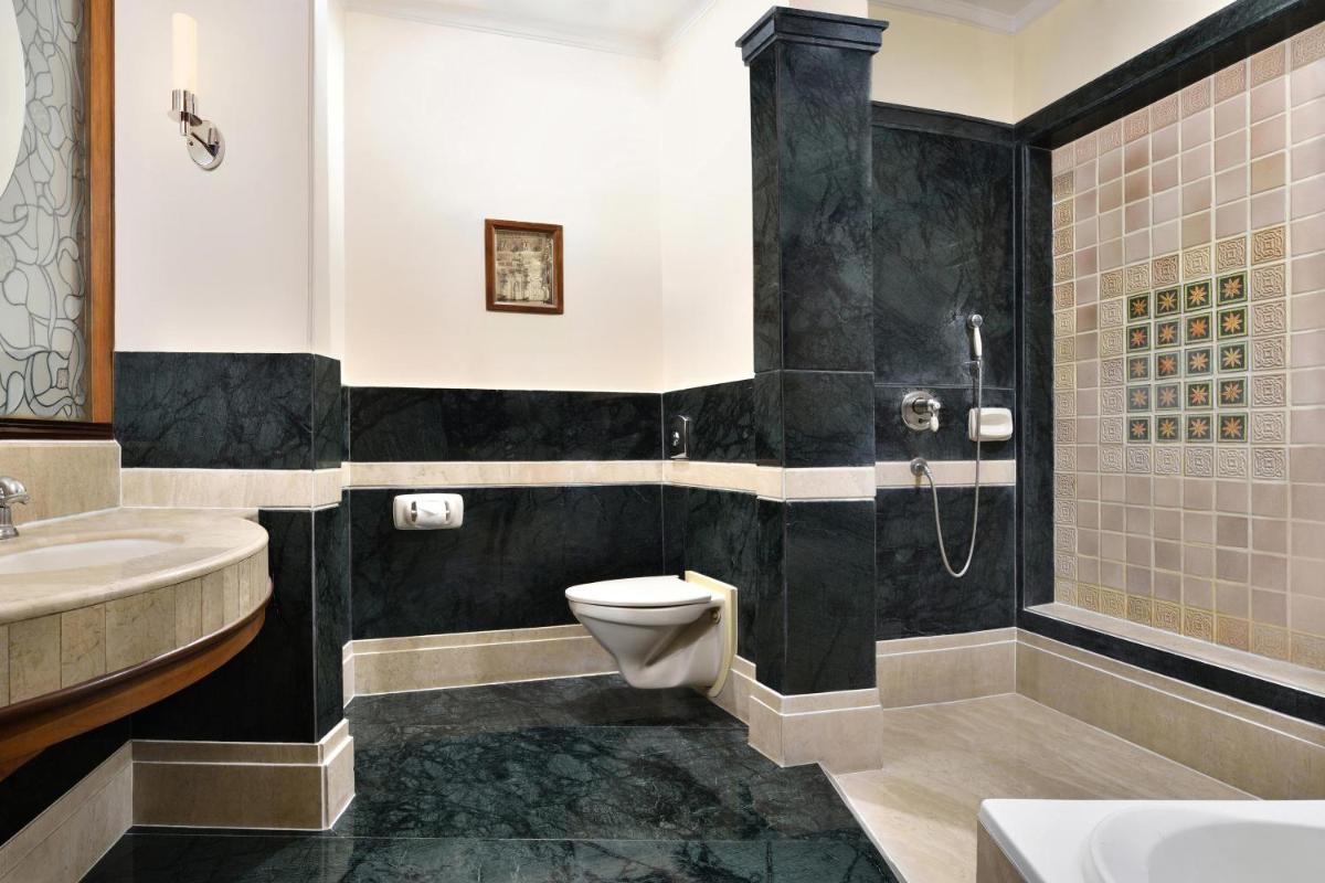 a bathroom with a toilet and a sink and a shower at Le Meridien Jaipur Resort & Spa in Jaipur