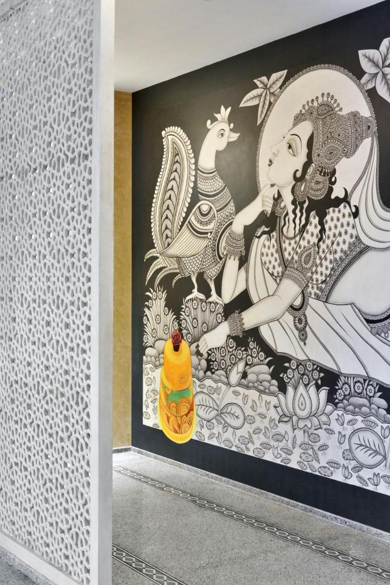 a mural of a woman and chickens on a wall at Le Meridien Jaipur Resort & Spa in Jaipur