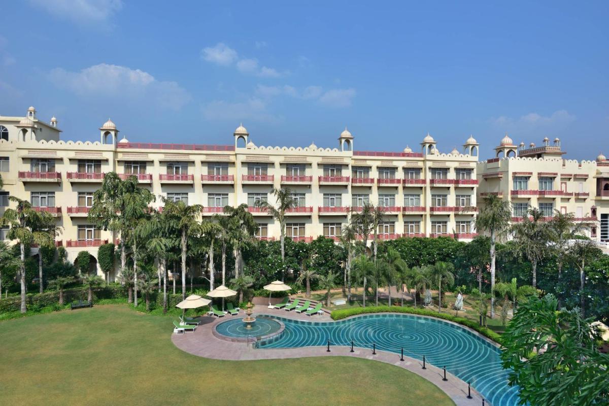 an exterior view of the resort with a large building at Le Meridien Jaipur Resort & Spa in Jaipur