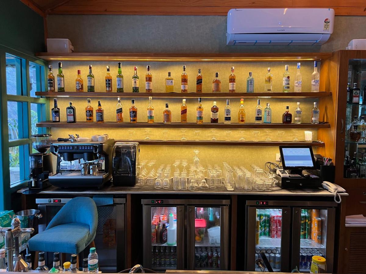 a bar with a lot of bottles of alcohol at Raga on the Ganges, Rishikesh in Rishīkesh