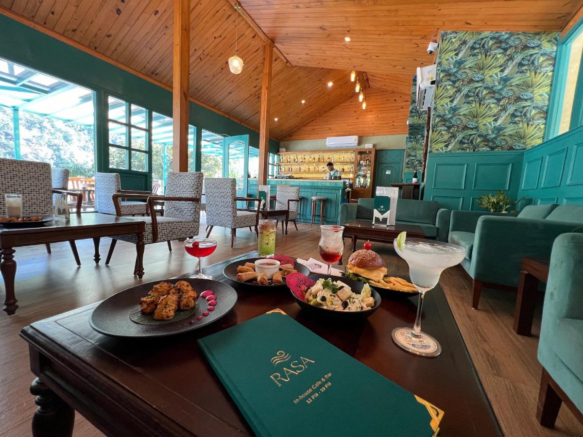 a dining room with a table with food and drinks at Raga on the Ganges, Rishikesh in Rishīkesh