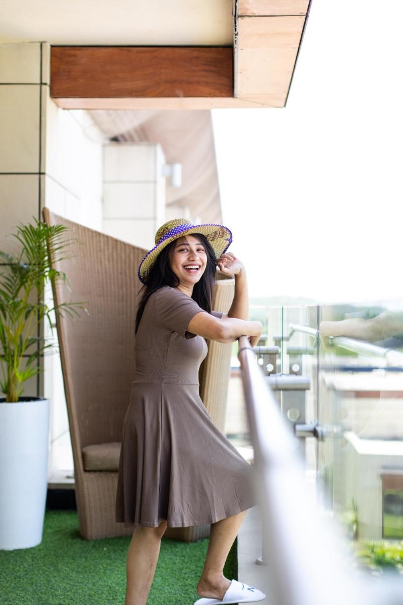 a woman wearing a hat standing in a chair at Novotel Hyderabad Airport in Hyderabad