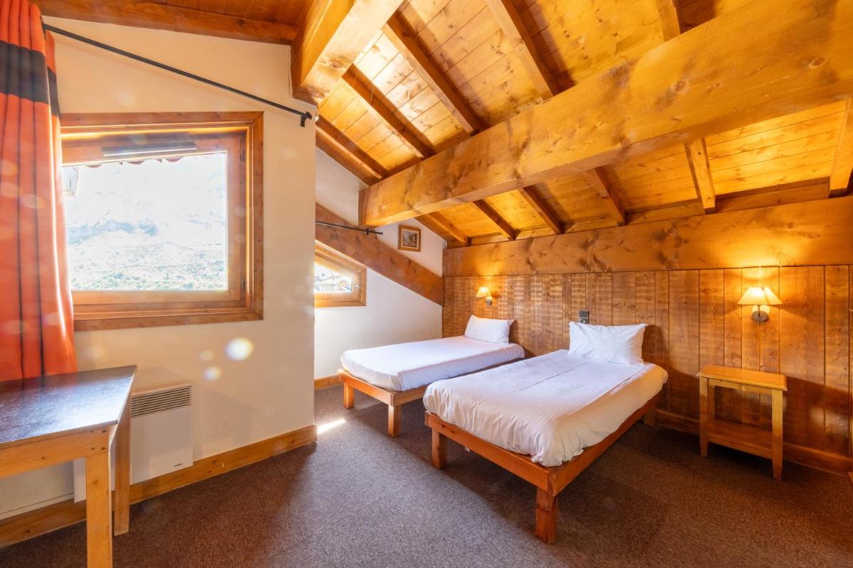 Un ou plusieurs lits dans un hébergement de l'établissement Résidences Village Montana by Les Etincelles