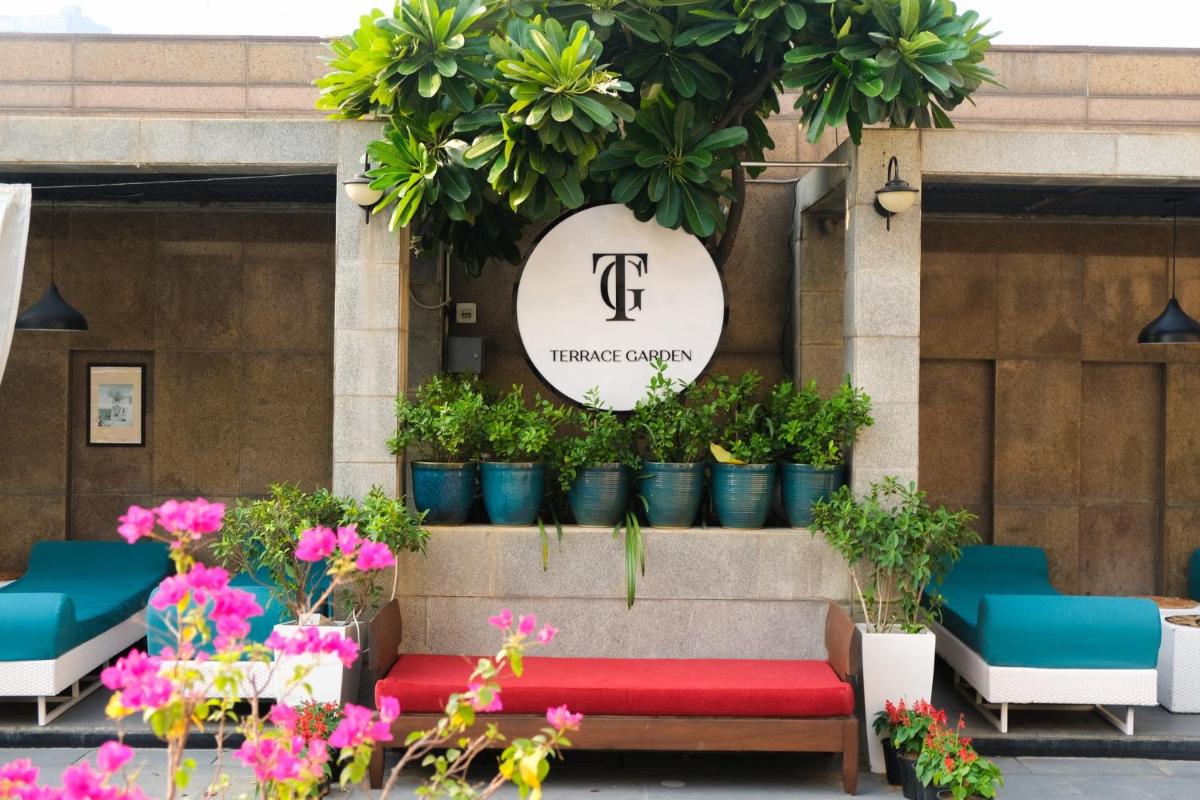 a bench in front of a flower shop with potted plants at Crowne Plaza Today Gurugram by IHG in Gurgaon