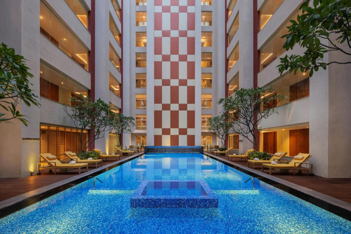 a swimming pool in the lobby of a hotel at Sheraton Hyderabad Hotel in Hyderabad