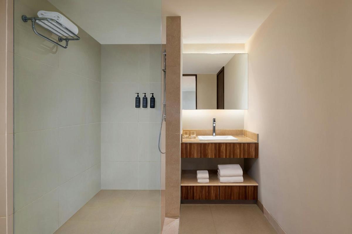 a bathroom with a shower and a sink at Sheraton Hyderabad Hotel in Hyderabad