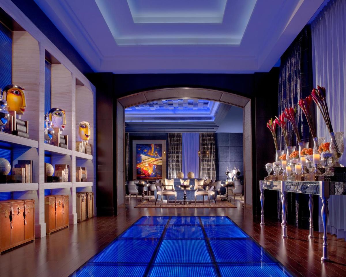 a swimming pool in a room with a ceiling at The Leela Palace Chennai in Chennai a swimming pool in a room with a ceiling at The Leela Palace Chennai in Chennai