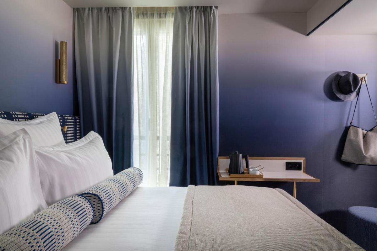 Un ou plusieurs lits dans un hébergement de l'établissement Hôtel Filigrane & Spa
