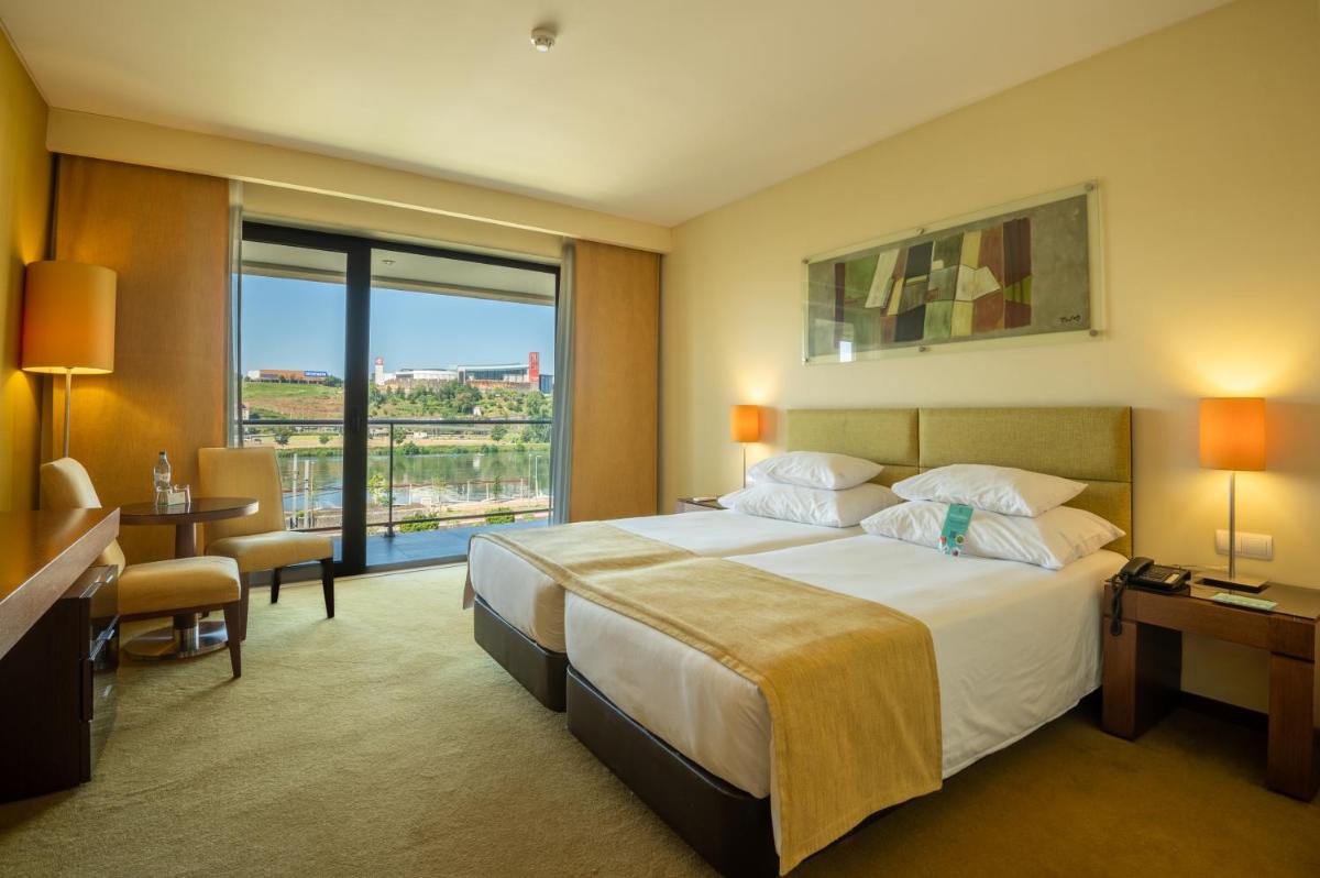 Uma cama ou camas num quarto em Vila Gale Coimbra