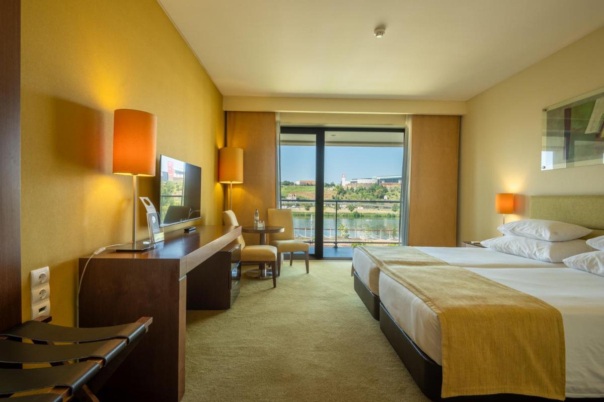 Uma cama ou camas num quarto em Vila Gale Coimbra