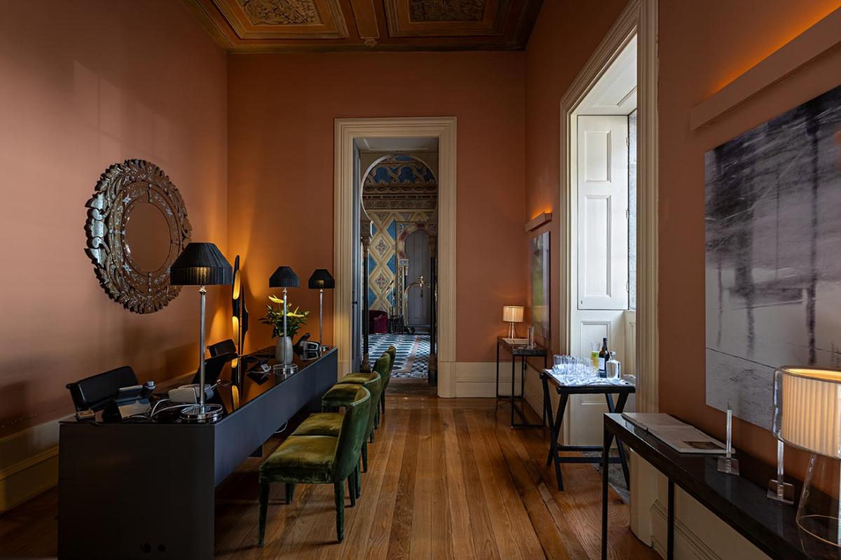 uma sala com cadeiras, uma mesa e um espelho em Pestana Palacio do Freixo, Pousada & National Monument - The Leading Hotels of the World no Porto