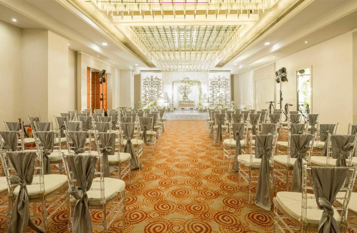 a banquet hall with rows of chairs in a room at Radisson Hyderabad Hitec City in Hyderabad