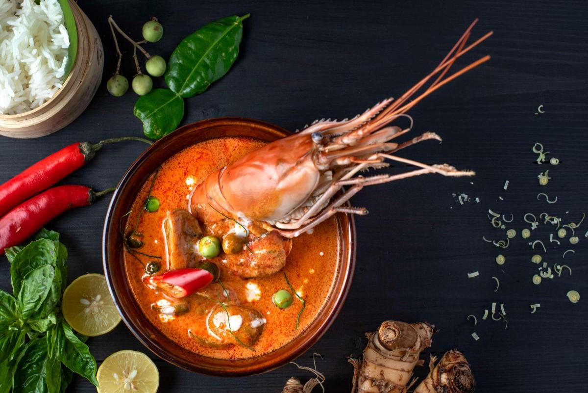 a plate of food with a shrimp in a sauce at Radisson Jaipur City Center in Jaipur