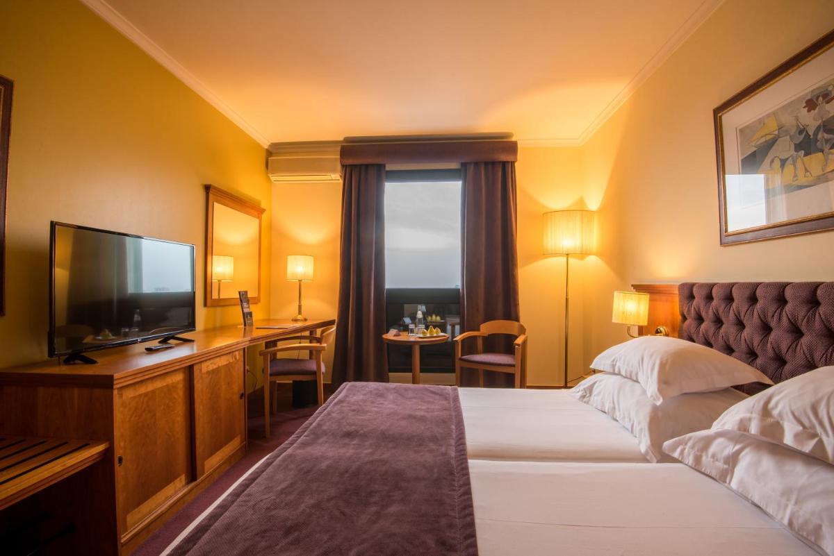 Uma cama ou camas num quarto em Vila Gale Porto - Centro