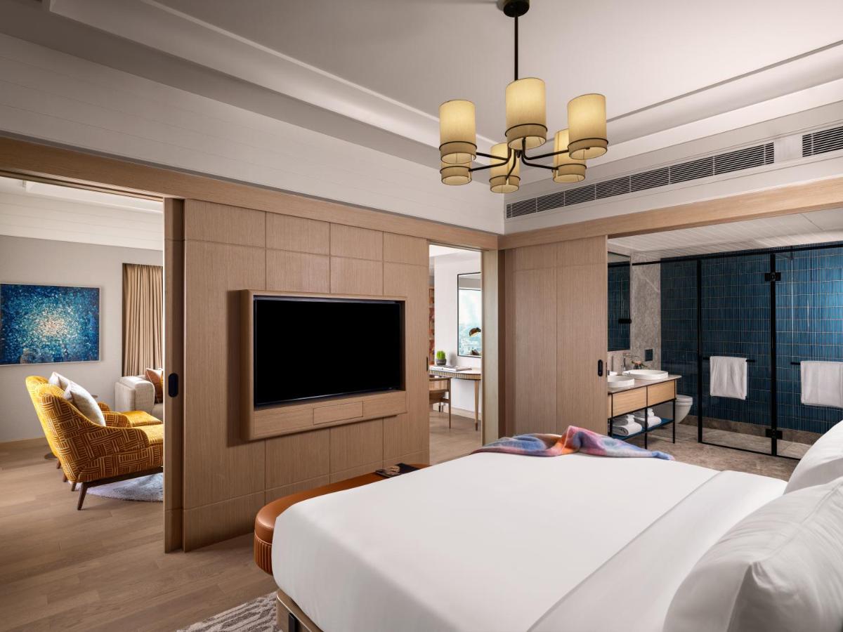 a bedroom with a bed and a flat screen tv at Pullman Chennai Anna Salai - Premium Brand By Accor in Chennai