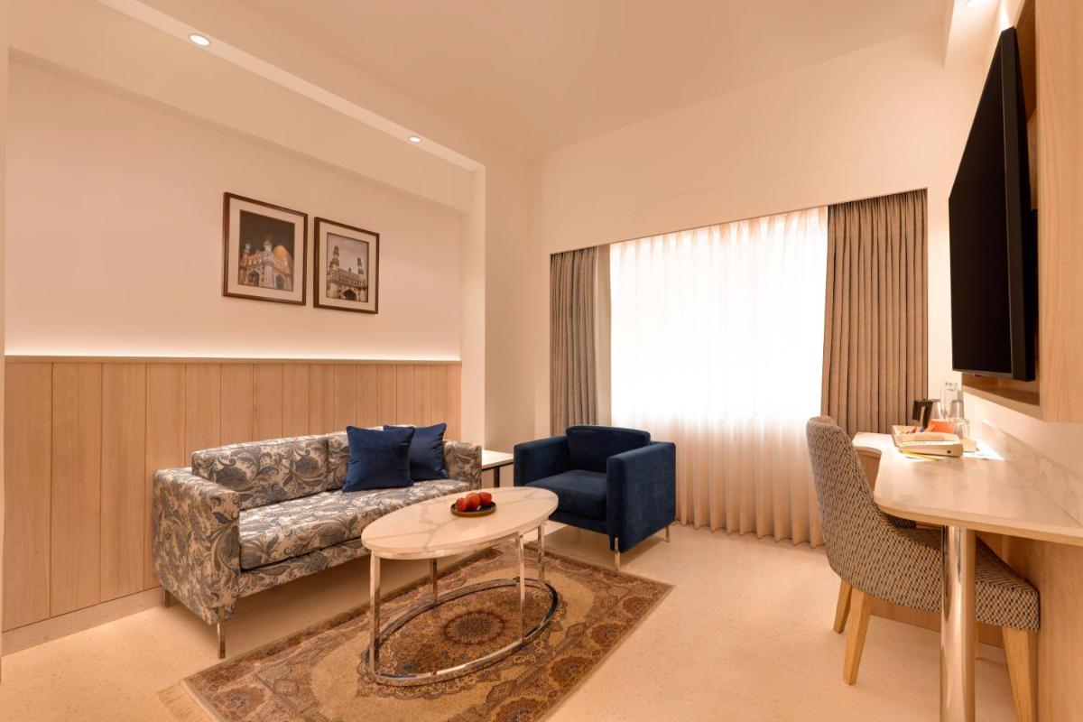 a living room with a couch and a table at Lemon Tree Premier Hitec City Hyderabad in Hyderabad