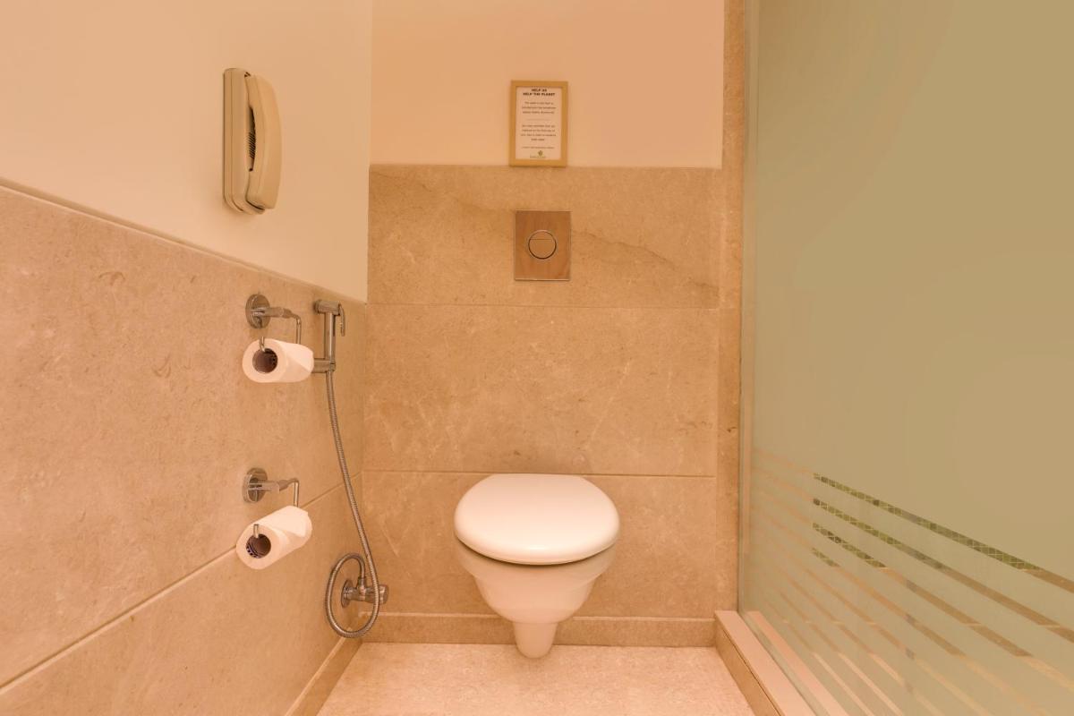 a bathroom with a toilet and a shower at Lemon Tree Premier Hitec City Hyderabad in Hyderabad