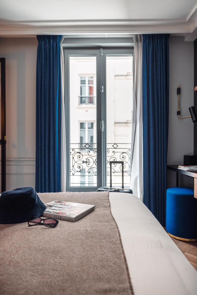 Un ou plusieurs lits dans un hébergement de l'établissement Maison ELLE Paris