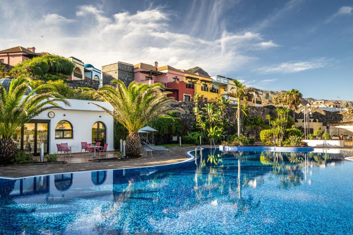 un complejo con piscina con palmeras y edificios en Luz Del Mar, en Los Silos