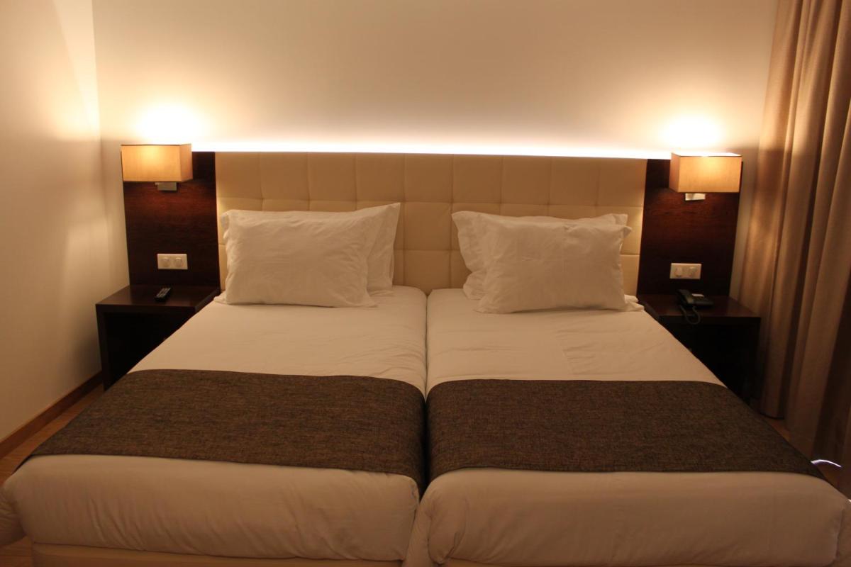 Uma cama ou camas num quarto em Hotel O Gato & Spa