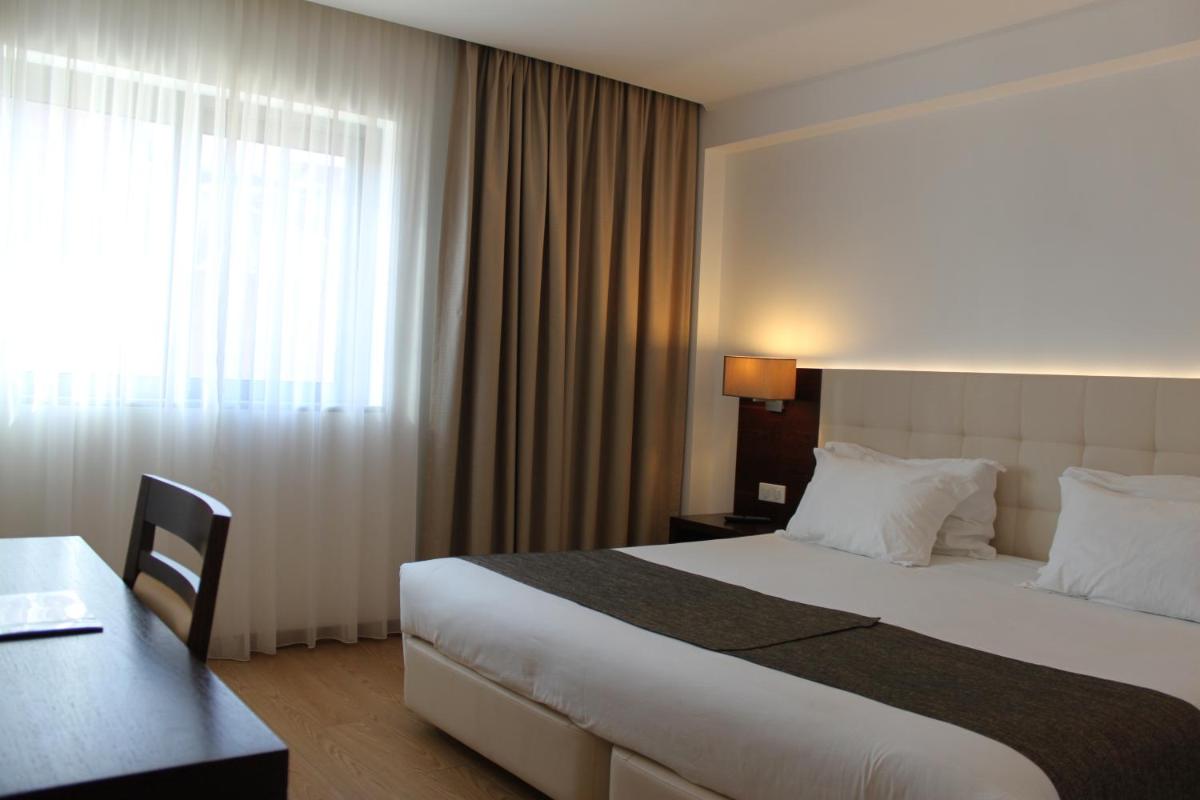 Uma cama ou camas num quarto em Hotel O Gato & Spa