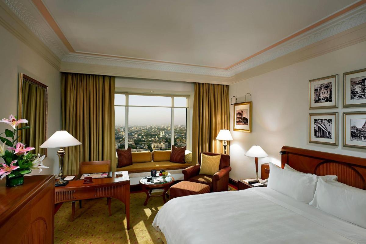 a hotel room with a bed and a living room at ITC Grand Central, a Luxury Collection Hotel, Mumbai in Mumbai
