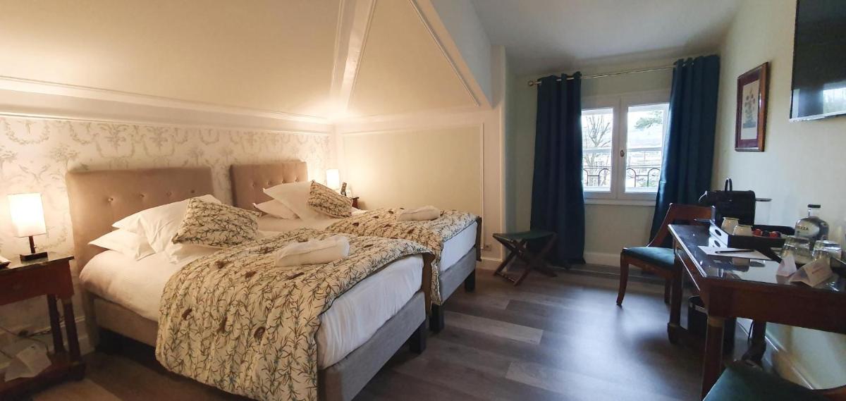 Un ou plusieurs lits dans un hébergement de l'établissement Demeures & Châteaux - Hôtel Greuze & Spa Tournus
