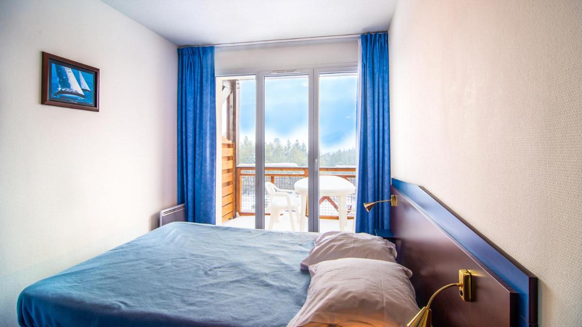 Un ou plusieurs lits dans un hébergement de l'établissement Vacancéole - Appart'Vacances Pyrénées 2000