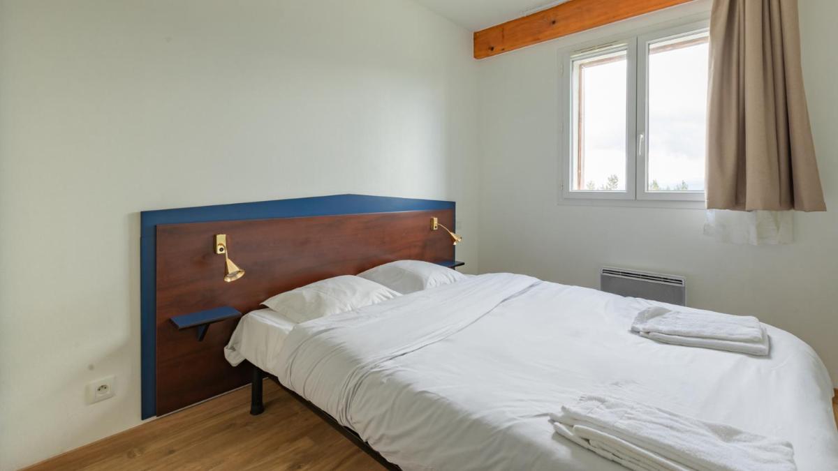Un ou plusieurs lits dans un hébergement de l'établissement Vacancéole - Appart'Vacances Pyrénées 2000